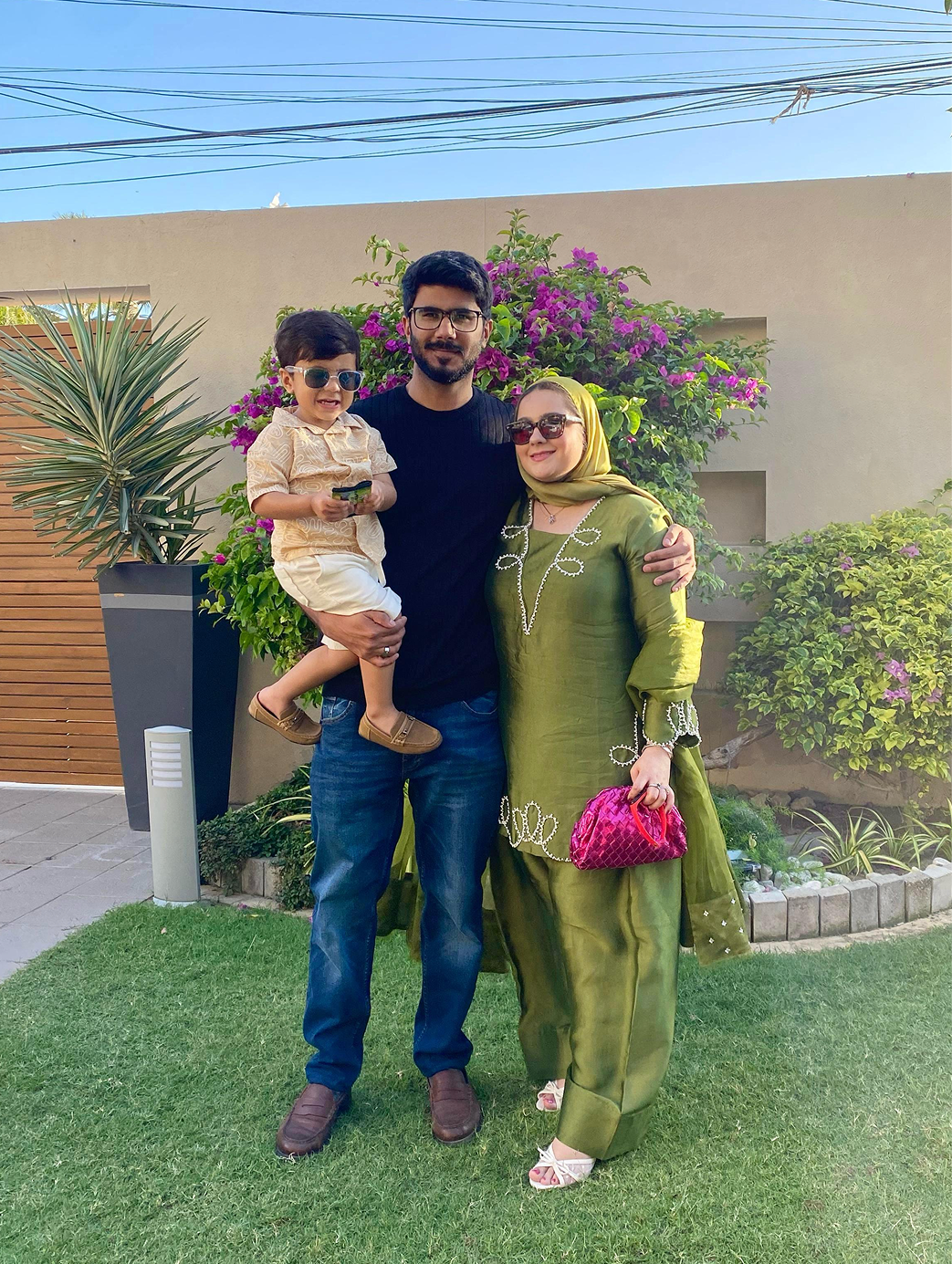A picture of Talha, Fatima and Nayel standing in a garden