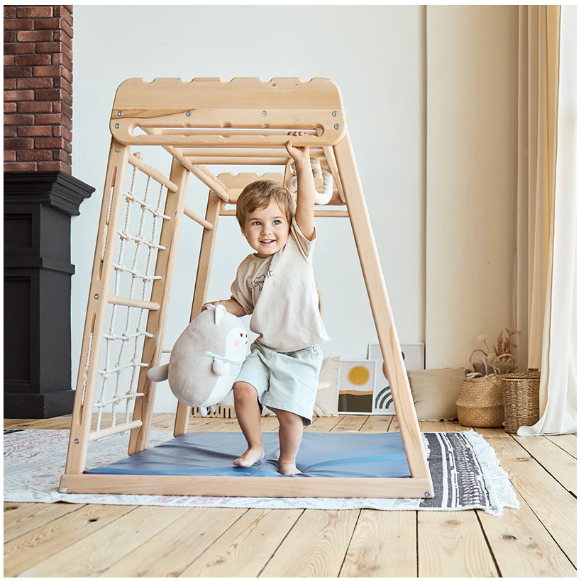 A picture of a kid hanging from jungle gym