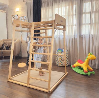 Child playing on a wooden jungle gym in a living room.